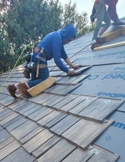 A Belter roofer installing shingles on an Oklahoma Roof.
