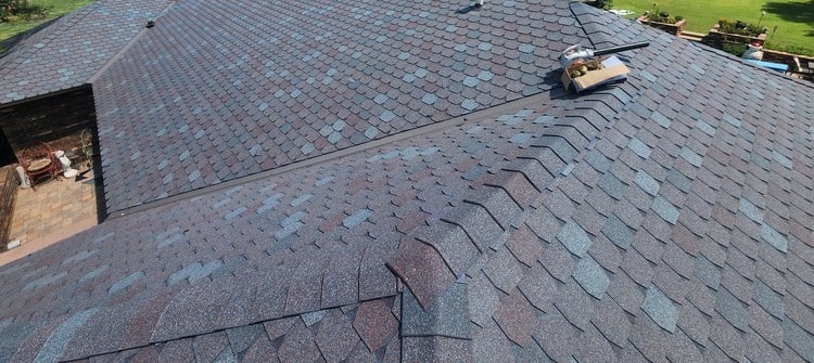 Oklahoma home roof being installed with asphalt shingles.