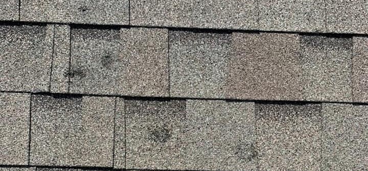 A roof showing signs of shingle granular lass due to an Oklahoma hail storm.