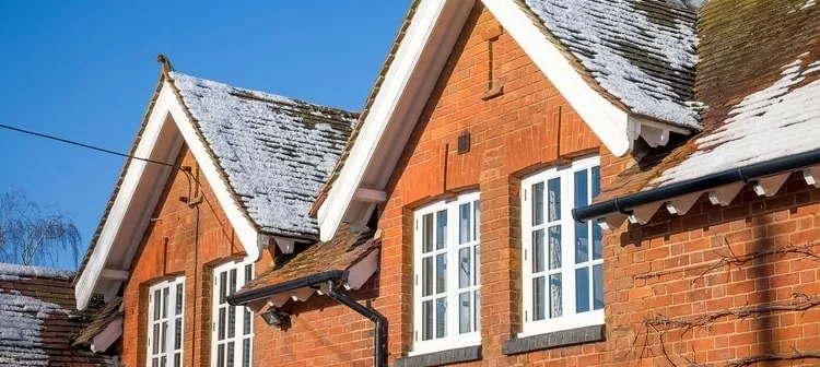 Snow accumulating on a residential roof.