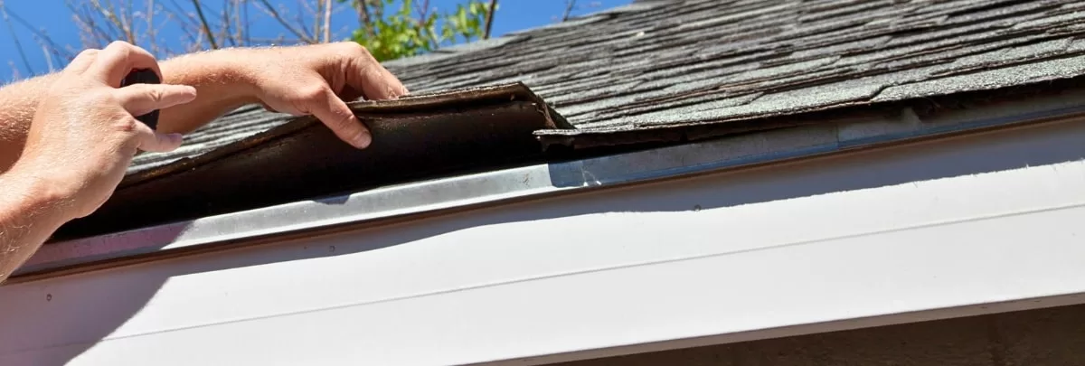 Homeowner doing Spring maintenance roofing tips in Oklahoma.