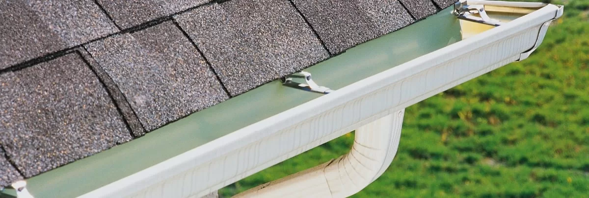 A well-maintained gutter system on a residential roof in Oklahoma, ensuring optimal roof health.
