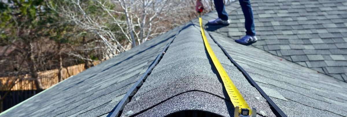 Professional Oklahoma roof contractor measuring a roof line. Learn about the top 10 roofing myths debunked.